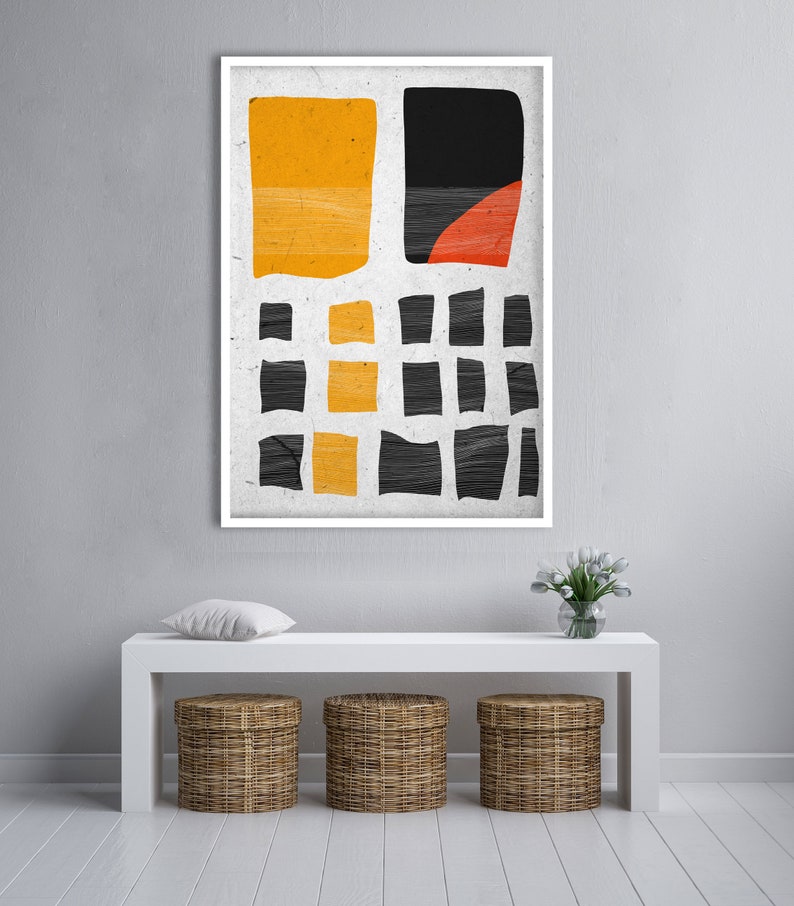 May include: Abstract art print in a white frame. The artwork features a textured, off-white background with yellow, black, and red geometric shapes. The shapes include rectangles and a semi-circle, creating a modern aesthetic.