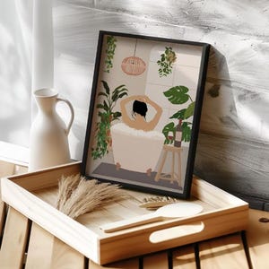 May include: A framed illustration of a person relaxing in a bathtub surrounded by plants. The person is facing away from the viewer and has their arms raised above their head. A glass of wine is on a small wooden stool next to the bathtub.