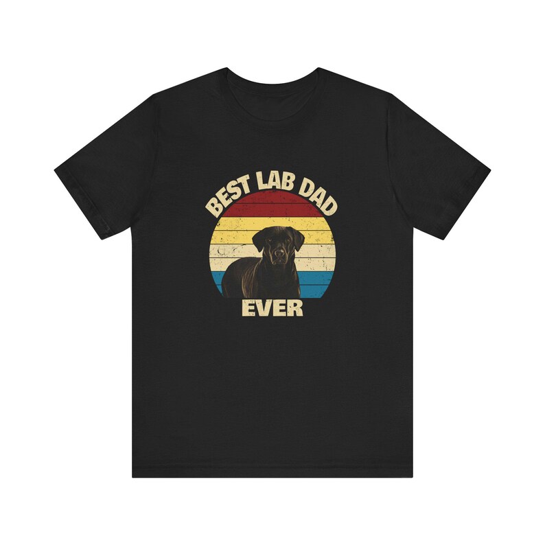 May include: Black t-shirt with a graphic of a Labrador Retriever inside a circular design. The text reads "Best Lab Dad Ever" above and below the dog. The design has a retro sunset colour scheme.