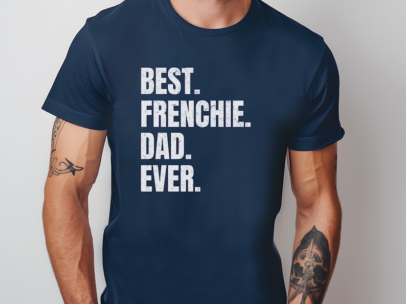May include: Navy blue t-shirt with the white text "BEST. FRENCHIE. DAD. EVER." The shirt is a solid color and has a crew neck. The text is in a bold, sans-serif font.