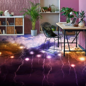 May include: A black metal chair with a gray cushion sits in front of a wooden desk with a laptop, a glass of water, and a potted plant. The floor is covered in a purple and orange lightning bolt pattern.