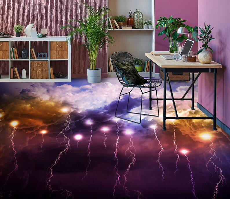 May include: A black metal chair with a gray cushion sits in front of a wooden desk with a laptop, a glass of water, and a potted plant. The floor is covered in a purple and orange lightning bolt pattern.