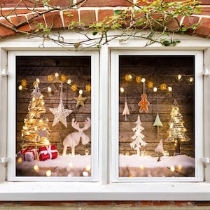 May include: A window with a wooden frame and a view of a Christmas scene. The scene includes a small Christmas tree with lights, a gingerbread man, and other decorations. The window is decorated with a garland of lights.