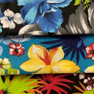 May include: Three fabric swatches with different tropical floral patterns. The top swatch features a blue flower on a black background. The middle swatch features a yellow flower on a blue background. The bottom swatch features a red flower on a black background.