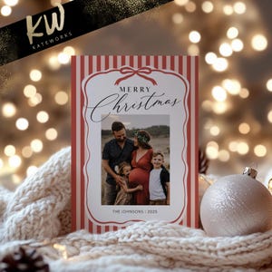 May include: Christmas card with a family photo inside a red and white striped border. The card reads "Merry Christmas" in elegant script. The family photo shows a couple with two children. The bottom of the card reads "THE JOHNSONS | 2025".