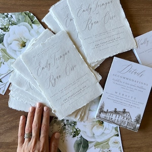 May include: Elegant wedding invitation suite featuring calligraphy text: "Emily Termyna and Ryan Orso." Includes invitation cards, details cards, and floral-printed envelopes. The invitation cards have deckled edges and the text "The Stagecoach Inn."
