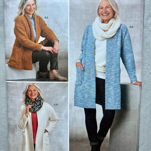 May include: Simplicity sewing pattern 8811 featuring three variations of an open-front cardigan with patch pockets. The pattern displays a textured brown cardigan, a blue heathered cardigan with a white cowl neck, and a cream cardigan with a scarf.