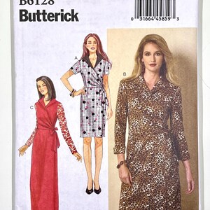 May include: A Butterick sewing pattern, B6128, featuring illustrations of three different wrap dresses. The pattern includes sizes 14-22. The dresses include a polka dot print, a leopard print, and a red dress with lace sleeves.
