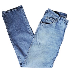 May include: A pair of light blue denim jeans folded in half. The jeans have a classic five-pocket style and a straight leg.