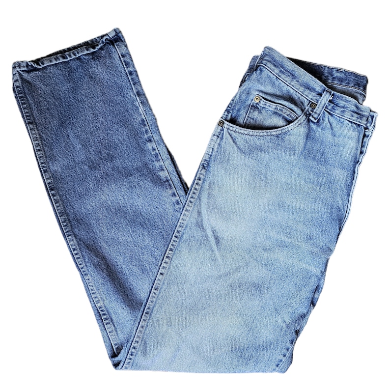 May include: A pair of light blue denim jeans folded in half. The jeans have a classic five-pocket style and a straight leg.