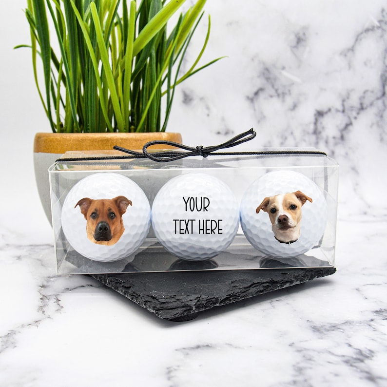 May include: Three white golf balls with personalized dog photos. The center ball has the text "YOUR TEXT HERE".
