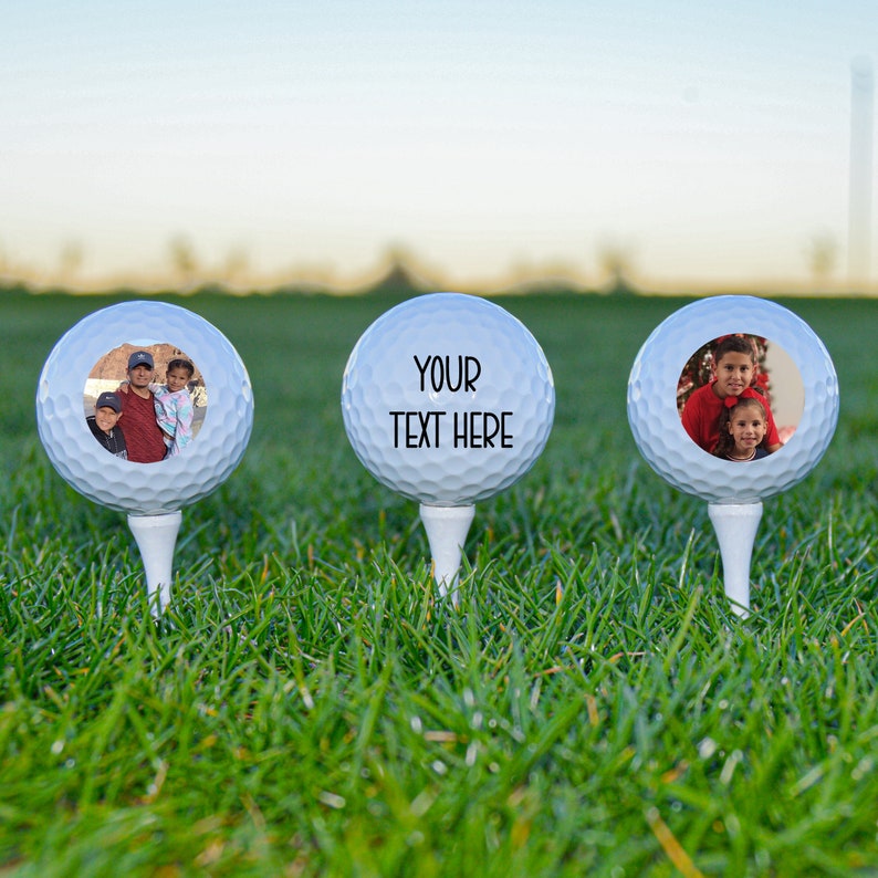 May include: Three white golf balls with personalized images and text. The first ball has a photo of a family of three. The second ball has the text "YOUR TEXT HERE". The third ball has a photo of two children.