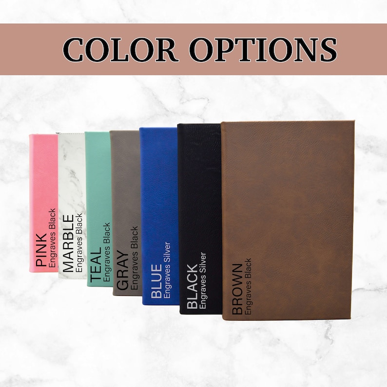 May include: Eight different color options for a leather bound journal. The colors are pink, marble, teal, gray, blue, black, and brown. Each color option has text indicating the color and whether it engraves in black or silver.