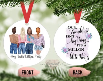 May include: A white round ornament with a watercolor background and the text "Our Friendship Isn't a Big Thing It's a Million Little Things". The front of the ornament features a drawing of four women standing together with their arms around each other. The women are wearing jeans and casual tops. The names "Amy Jackie Kaitlynn Karly" are written below the women.