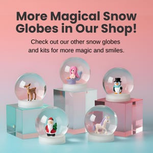 May include: An assortment of snow globes with various figurines inside, including a deer, mermaid, penguin, Santa Claus, and unicorn. The globes are displayed on clear and pink pedestals. Text at the top reads "More Magical Snow Globes in Our Shop!"
