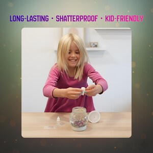 May include: A young person is assembling a snow globe kit. The kit includes a glass jar with a white base, a white lid, and small decorative elements inside. The text on the image reads: LONG-LASTING &bull; SHATTERPROOF &bull; KID-FRIENDLY.