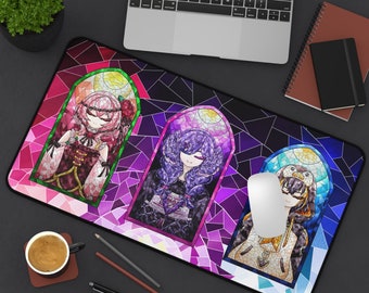 May include: A colorful mouse pad with a stained glass design featuring three figures with long hair and intricate clothing. The figures are set against a background of purple, pink, and blue stained glass.
