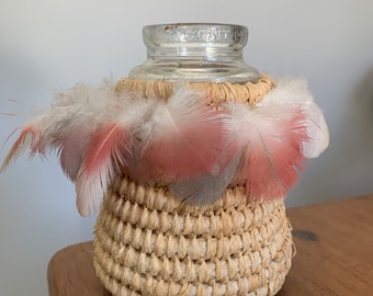 Handmade aboriginal weaving covered vintage bottle with pink galah feathers