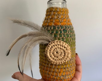 Handmade aboriginal weaving covered vintage third pint milk bottle with emu feathers