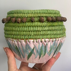 Handmade clay base aboriginal weaving with gum leaves  and gum nuts  basket