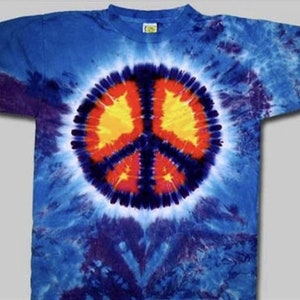 May include: A blue tie-dye t-shirt with a large peace sign in the center. The peace sign is red, orange, yellow, and blue.