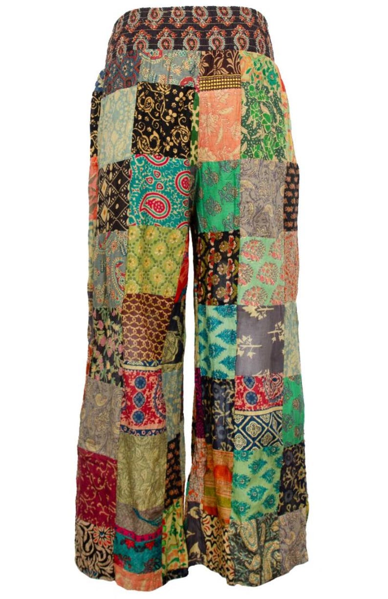 May include: Wide-leg pants with a patchwork design featuring a variety of colorful floral patterns. The pants have a wide, flowing silhouette and a comfortable elastic waistband.
