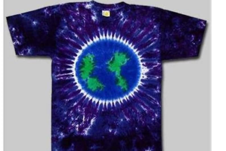 May include: A tie-dye t-shirt with a blue, green, and white earth design in the center. The shirt is a dark purple color with white swirls.