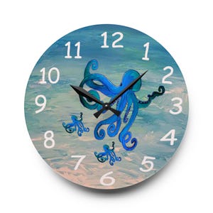 May include: Round wall clock featuring a blue octopus design on a watercolor background. The clock face has white numerals and black clock hands. The octopus illustration includes three octopuses in shades of blue.