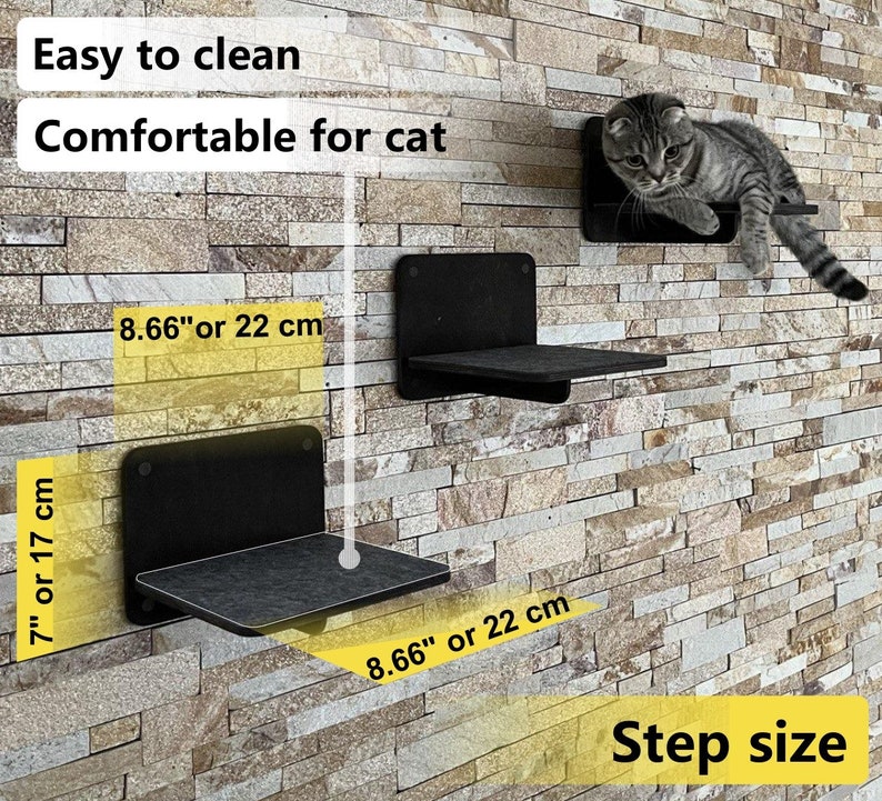 May include: Three black cat shelves mounted on a stone wall. The shelves are 8.66 inches or 22 centimeters wide and 7 inches or 17 centimeters deep. The text "Easy to clean" and "Comfortable for cat" is written above the shelves. The text "Step size" is written below the shelves.