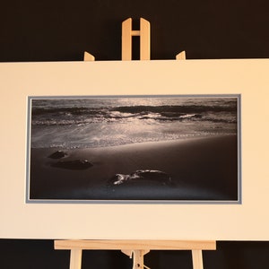 Stones and Surf - double mounted black and white atmospheric photograph of stones on shoreline. 16(w) x 10(h) inches