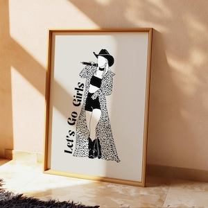 May include: Black and white line art print of a woman wearing a cowboy hat and a leopard print coat. The text "Let's Go Girls" is printed on the left side of the image.