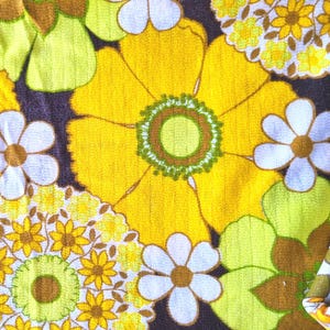 May include: A fabric with a retro floral pattern in shades of yellow, green, brown, and white. The fabric features large and small flowers with a repeating pattern.