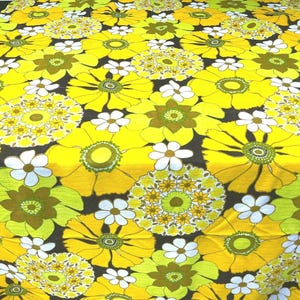 May include: Yellow and green floral fabric with a repeating pattern of large and small flowers. The fabric has a retro 1970s style.