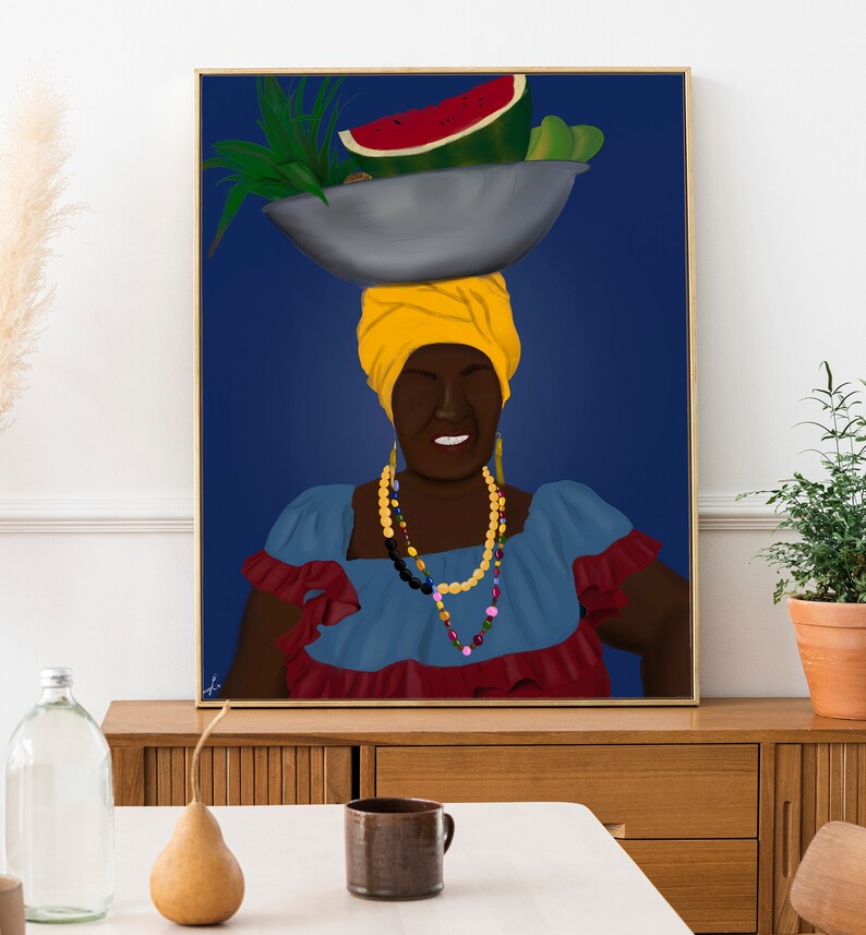 May include: A woman with a yellow headscarf and colorful beaded necklaces is smiling while carrying a bowl of fruit on her head. The fruit includes a watermelon, green peppers, and other tropical fruits. The background is a dark blue.