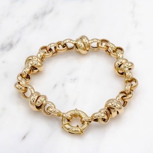 14 karat yellow gold rolo link with love knot bracelet