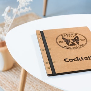 Elevate your brand with our Wooden Menu Holder featuring Logo Engraving. Personalize your presentation with ease using this handcrafted menu folder. Easily swap pages for a fresh, sophisticated look. Discover elegance with our Wooden Menu Cover.