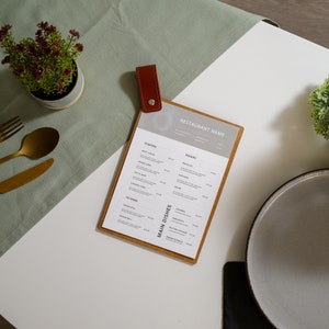 Customized wooden menu holder tailored to reflect your restaurant's style. Elevate your branding with this personalized menu display option.