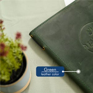 Close-up of the right edge of a dark forest green Crazy Horse leather menu cover showing the gold screw post binding hardware set into the genuine aged leather surface. The rich dark green leather with natural color variation and authentic Crazy Horse texture patina clearly visible around the hardware detail. Durable screw post binding for daily cafe and restaurant menu holder use in fine dining venues.