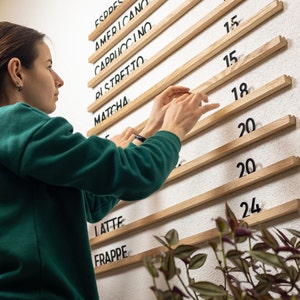 Elevate your restaurant's ambiance with this sleek menu board, boasting high-quality oak rails and clear acrylic letters, providing a sophisticated and easily readable display of your menu offerings for patrons to enjoy.