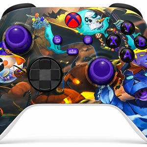 May include: A wireless video game controller featuring a vibrant Halloween-themed graphic wrap. The design displays a skeleton, a mummy, and jack-o'-lanterns in orange, blue, and purple hues. It includes two purple thumbsticks and black buttons.