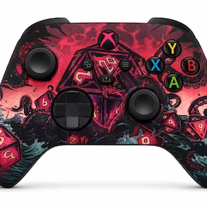May include: A wireless video game controller featuring a red and black graphic print of a sea monster with tentacles emerging from waves, surrounded by multi-sided dice. The controller includes black joysticks, a D-pad, and coloured A, B, X, Y buttons.