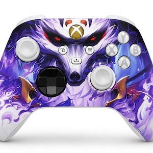 May include: A wireless video game controller featuring a white base with a graphic illustration of a stylised wolf face with red eyes surrounded by swirling purple and blue flames. The controller includes a black D-pad, white joysticks, and buttons.