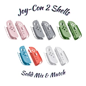 Könnte beinhalten: Eine Auswahl an Joy-Con 2 Shells in verschiedenen unifarbenen Farben, darunter Rosa, Grau, Grün, Blau, Rot und Weiß. Das Bild zeigt den Text "Joy-Con 2 Shells" und "Solid Mix & Match".