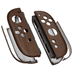 May include: Two brown wood-effect Joy-Con controller shells for a games console. The shells are shown apart, displaying the internal parts. The design includes button cutouts and a modern, stylish appearance.