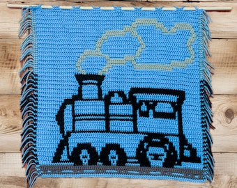 May include: A blue crocheted wall hanging with a black and white train design. The train has a plume of smoke coming from the chimney. The hanging has a fringe border.