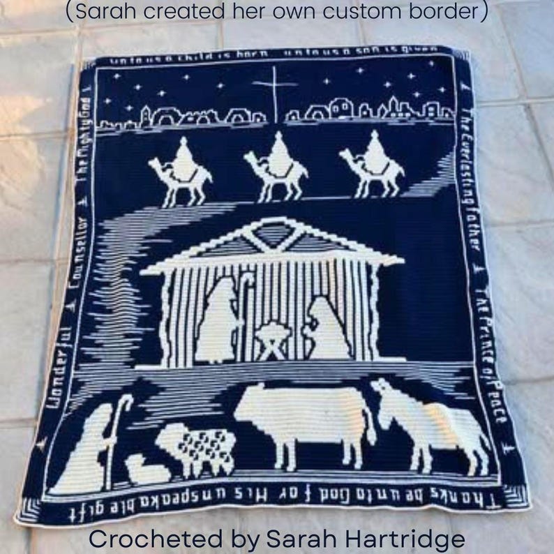 May include: A navy blue and white crocheted blanket featuring a nativity scene. The design includes the holy family, wise men, animals, and text. The blanket has a border with additional text. The text includes "Wonderful Counselor" and "Thanks be unto God for His unspeakable gift."