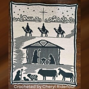 May include: A crocheted blanket featuring a nativity scene in black and white. The design includes silhouettes of the three wise men on camels, a stable, and various animals. The text "Crocheted by Cheryl Ridenour" is at the bottom.