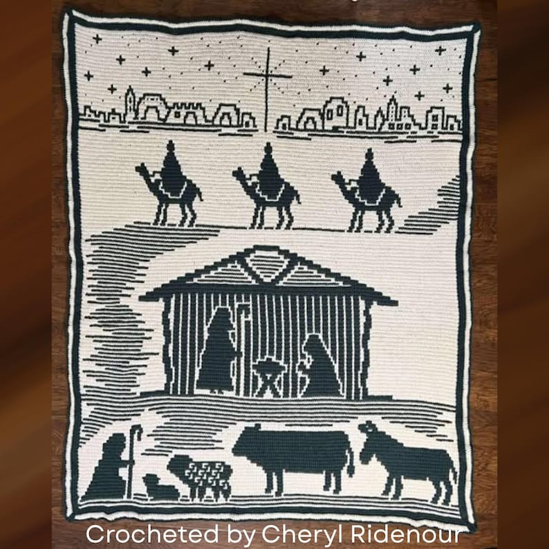 May include: A crocheted blanket featuring a nativity scene in black and white. The design includes silhouettes of the three wise men on camels, a stable, and various animals. The text "Crocheted by Cheryl Ridenour" is at the bottom.