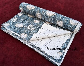May include: A white and gray kantha quilt with a floral pattern. The quilt is folded in half and has a white background with gray stitching. The quilt is made of cotton and is hand-stitched.