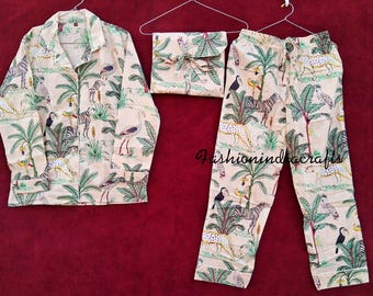 May include: A beige pajama set with a jungle print featuring animals like zebras, birds, and leopards. The set includes a long-sleeved shirt with a button-up collar and matching pants.